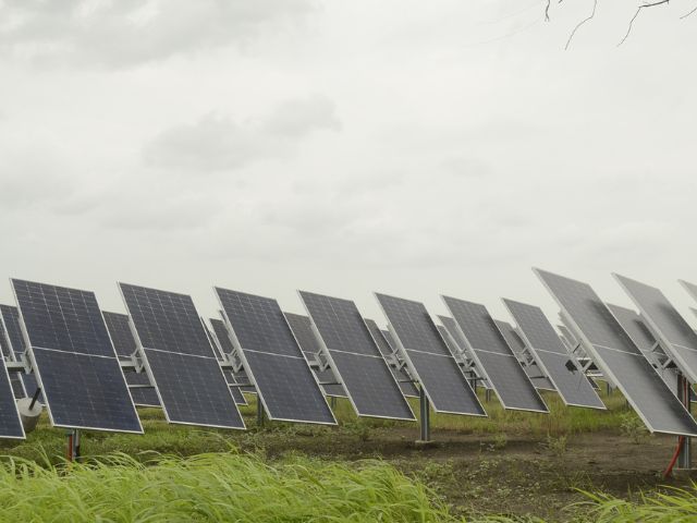 A dual-axis solar tracker adjusting the angle of a solar panel to follow the sun's path.